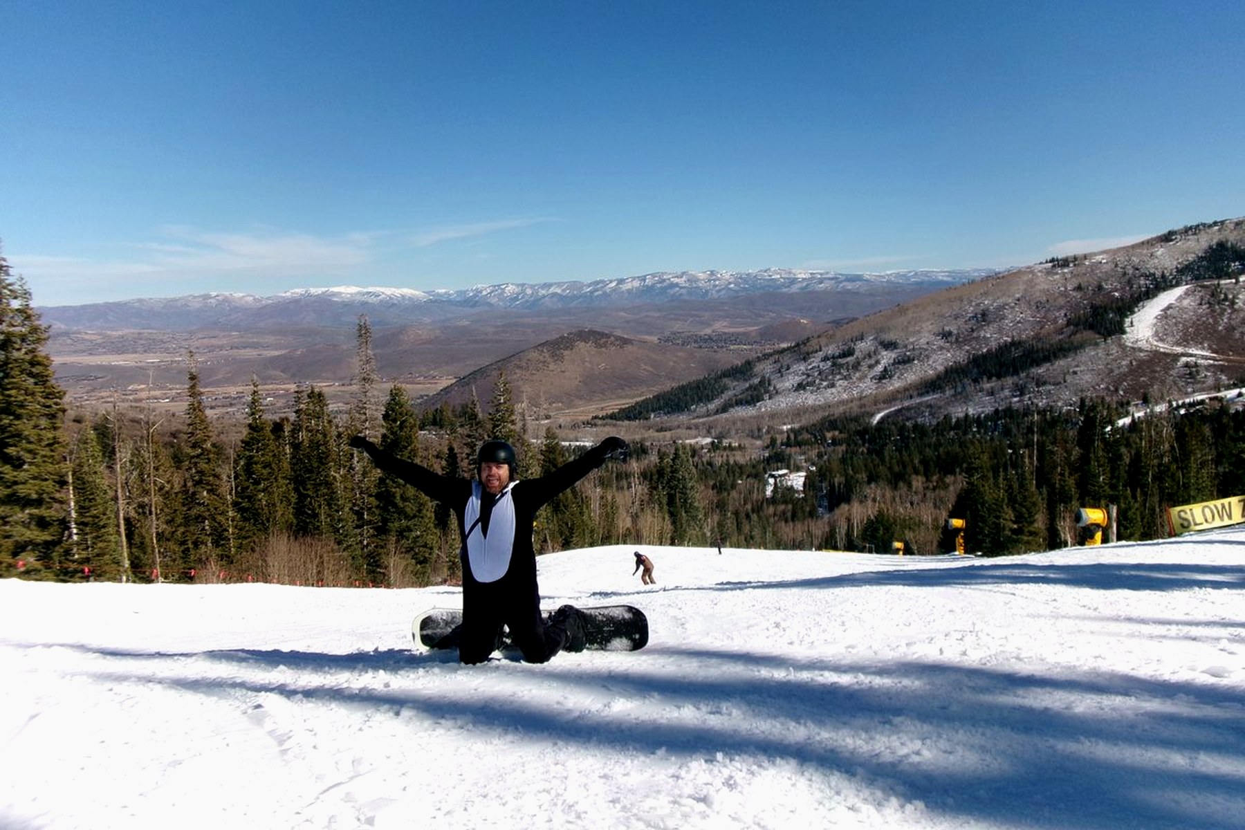 Snowboarder on a mountain slope under blue sky