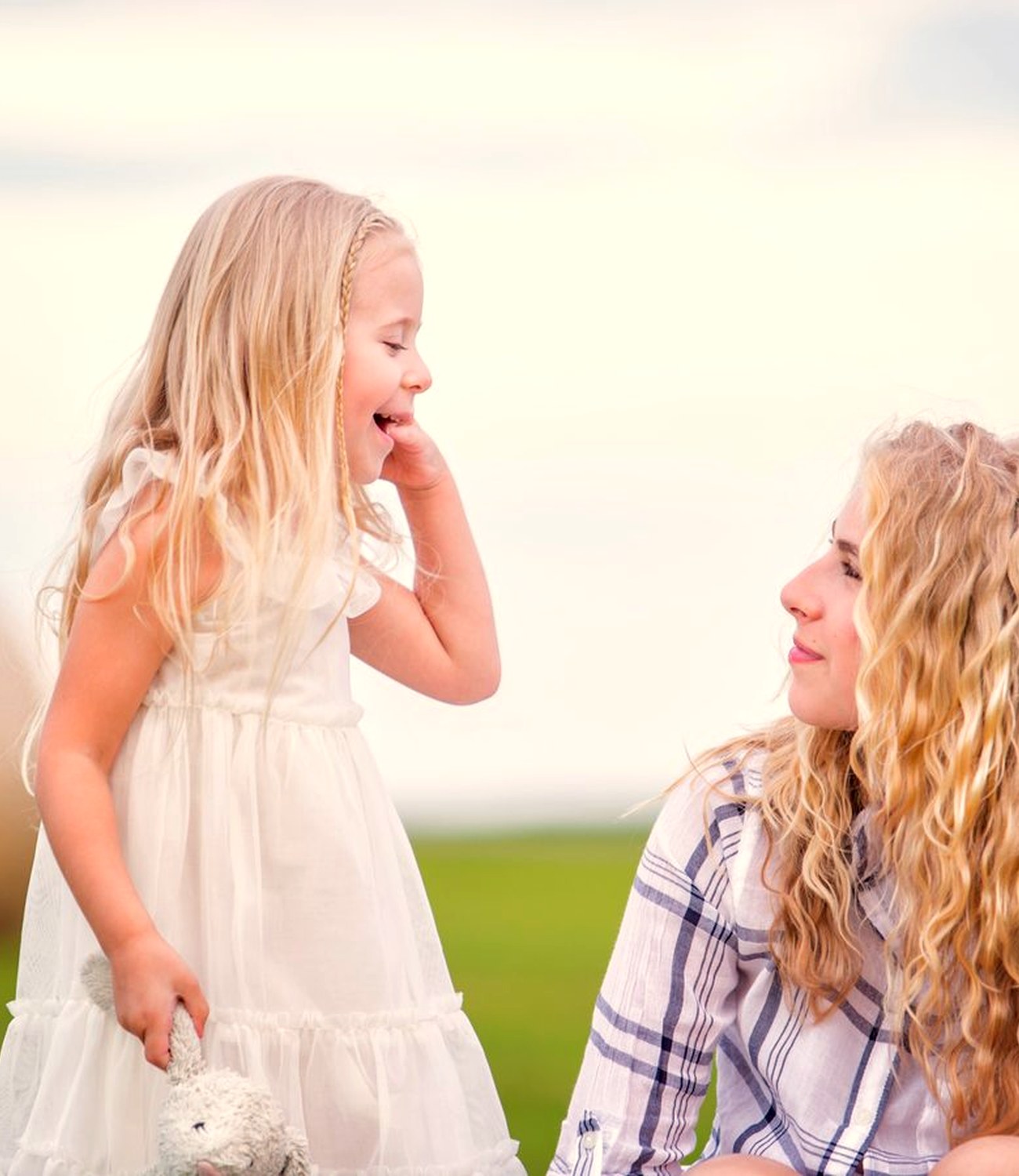 Two children sharing a candid moment outdoors